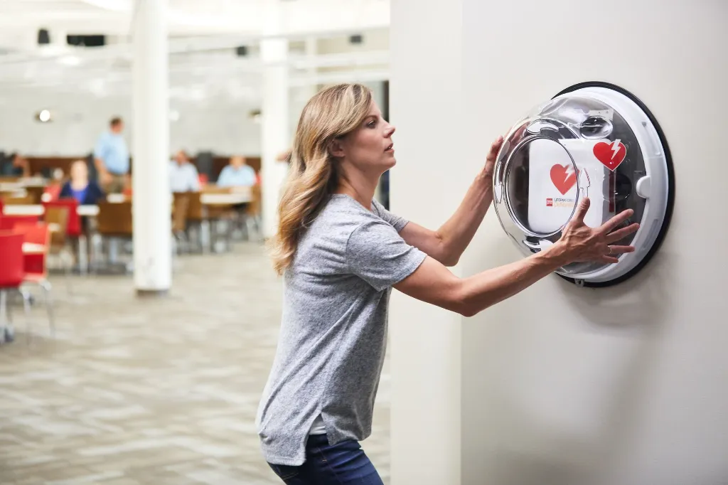 LIFEPAK CR2 In-Use - Woman Runs to AED in Rotaid Cabinet.webp